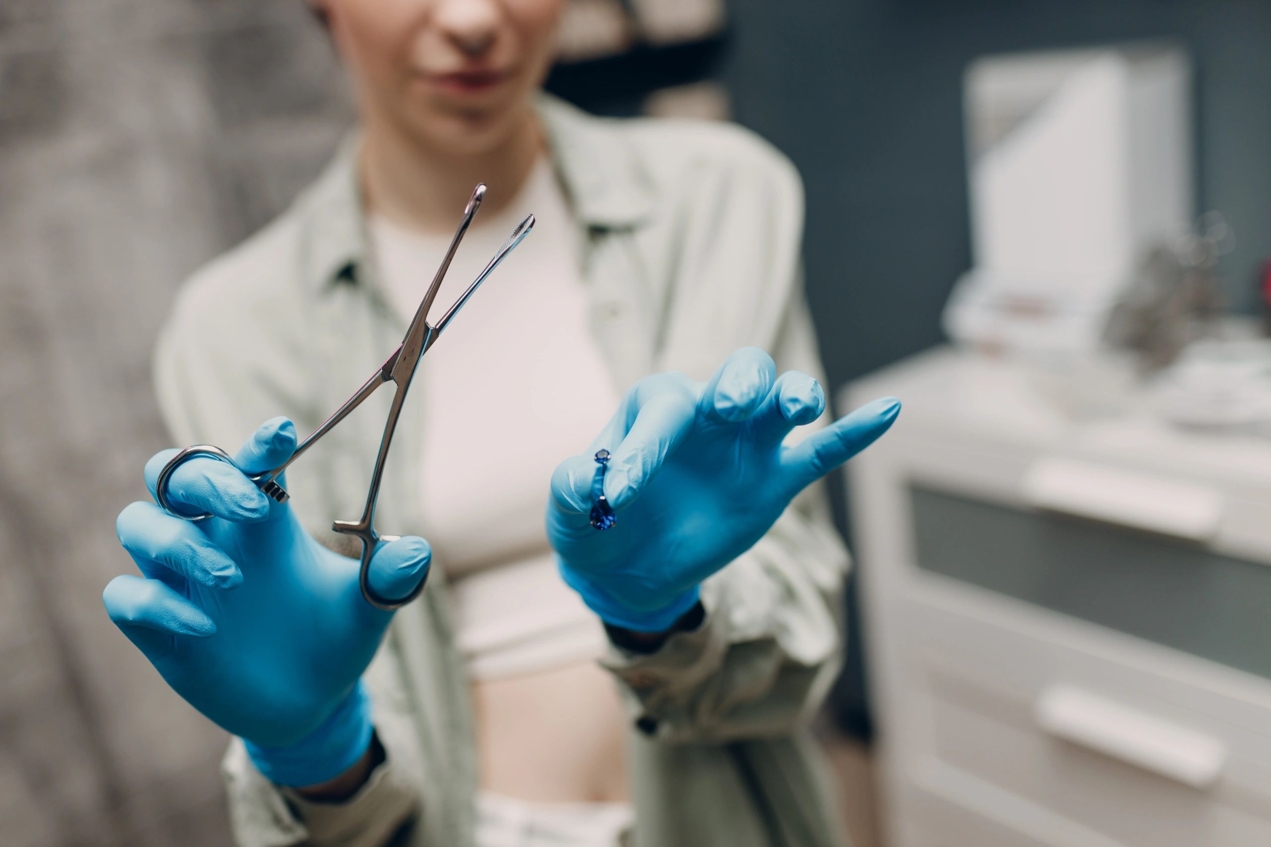 female piercer with gloves professional piercing
