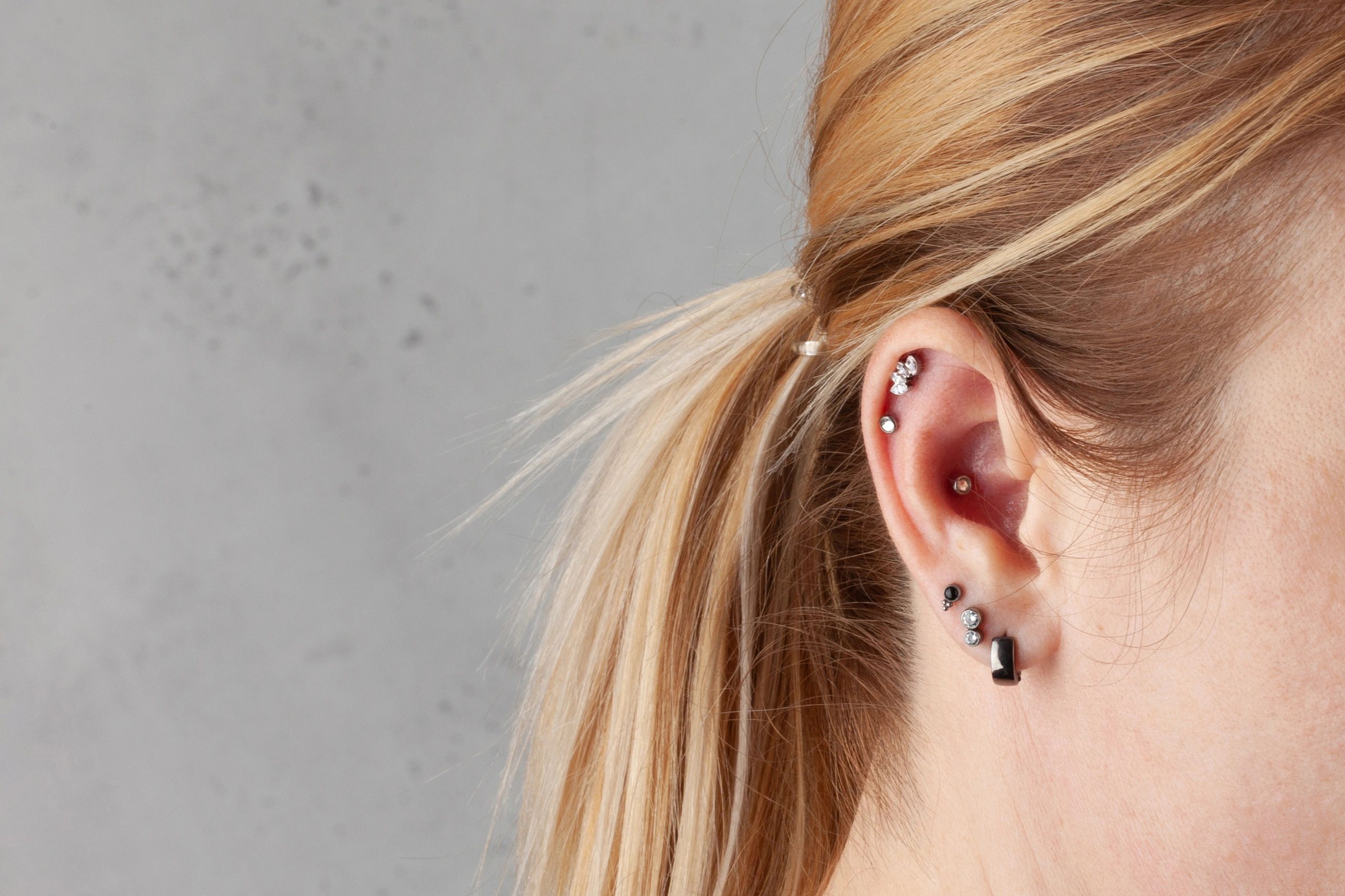 body piercing close up ear nose industrial style