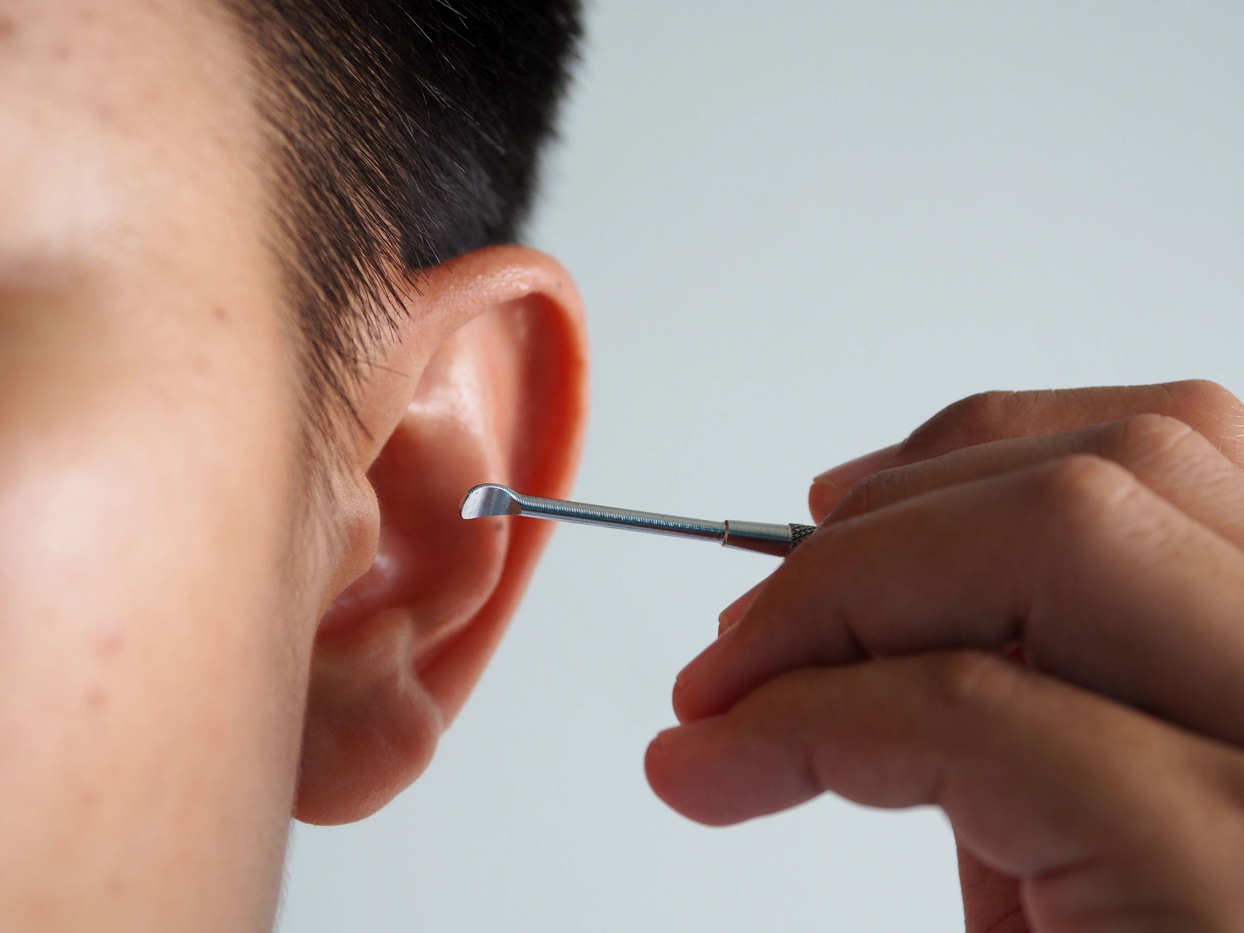 body piercing close up ear nose industrial style